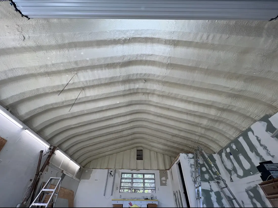 Spray polyurethane foam applied to the underside of a metal roof deck in Newark